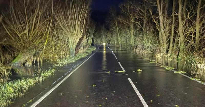 Water on flood-prone road turning to ice as temperature plummets below zero