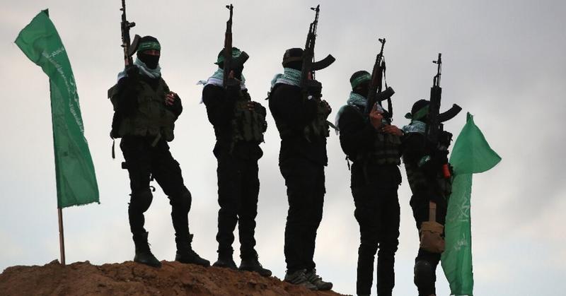 Hamas hands over dead Israeli hostages in black coffins